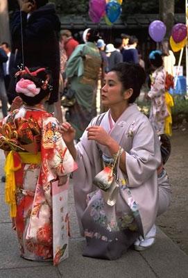 Every year on November 15, Japan celebrates Shichi-Go-San--Children's Day. Dressed in their very finest garments, girls and boys aged three, boys aged five, and girls aged seven, go with their families to nearby shrines, where they line up, sometimes for hours, to await their turn to be blessed by the presiding priest. After the blessing, the child is presented with a gift of long sticks of candy called chitose-ame, "thousand year sweets," wrapped in ornate bags decorated with cranes and turtles, both symbols of longevity.