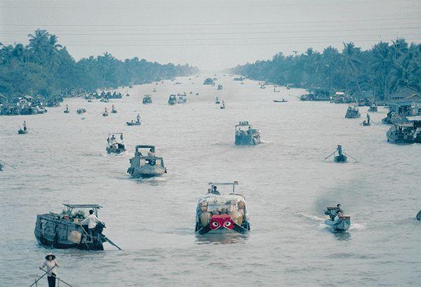 Boats laden with goods make their way down a canal in the Mekong Delta, one of seven such canals that meet near the town of Phung Hiep.