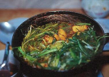 Braised fish sautéed with fresh herbs at the Cha Ca La Vong Restaurant, Hanoi, Vietnam.