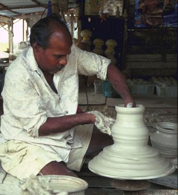 As the wheel turns, the clay seems to become liquid, flowing gracefully between Krishnan’s fingers.