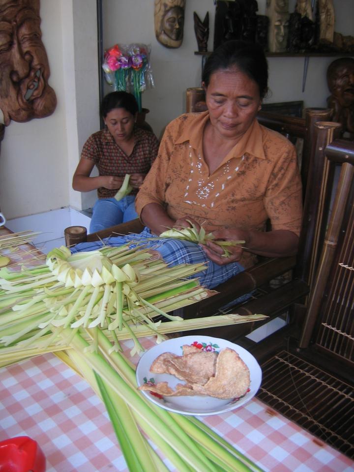 Women weaving baskets for morning offerings. 