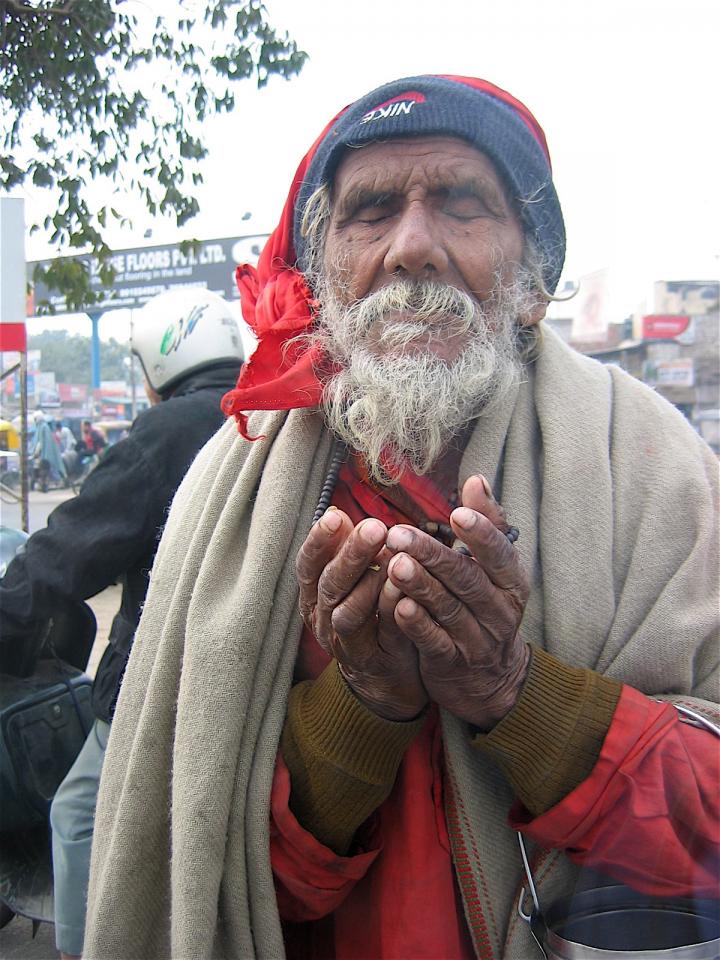 A blind man begs for money in New Delhi