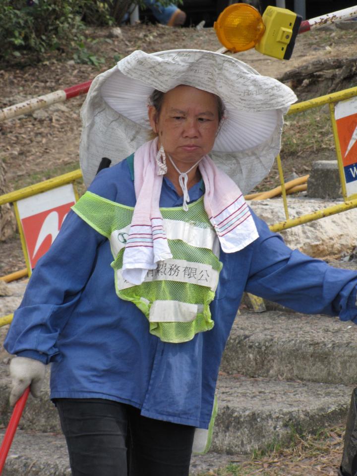 Street cleaners in Hong Kong have unique headgear. 