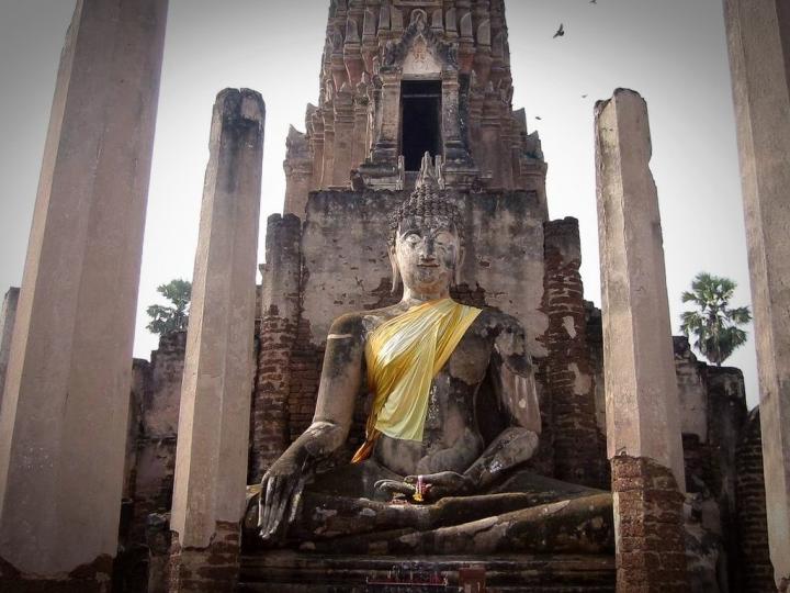 Buddha image in front of Wat Phra Prang at historical park