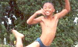 River Flight. A Lopburi schoolboy leaps for joy.