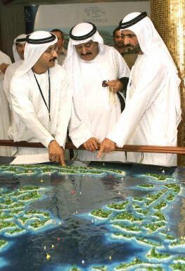 Crown Prince Sheikh Mohammed bin Rashed al-Maktum (R) looks at a display showing the Atlantis man-made island project during a launching ceremony of the luxurious 2,000-room resort and water theme park off the coast of Dubai, 21 September 2003 at a hotel in the Gulf emirate. The 650-million dollar first phase of the Atlantis' project, which is inspired by Kerzner International's Paradise Island in the Bahamas, adds to a boom in tourist infrastructure investment in Dubai, including the construction of dozens more five-star hotels. The project is a joint venture between Kerzner and Dubai's property developer Nakheel LLC.