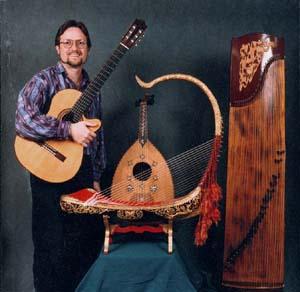 Musicologist Rick Heizman with some of his favorite musical instruments: In the center is a Burmese saung gauk, behind it is a Middle Eastern oud from Syria, on the right is a Chinese zheng.