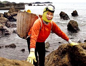 Kotoyo Motohashi, 68, Japan's legendary 'Ama' woman shellfish diver, smiles at a sea shore in Shirahama city, 100km southeast of Tokyo. Motohashi has been diving without tanks since the age of 18.