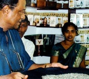 Sri Lankan master tea maker Malinga Herman Gunaratne (L) shows his exotic 'Kilburn Imperial' tea at his Handuugoda tea plantation in southern Sri Lanka.