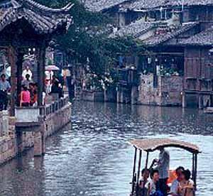 Wuzhen, Zhejiang, China. Visitors take a cruise on the Beijing-Hangzhou Grand Canal, thru Wuzhen.