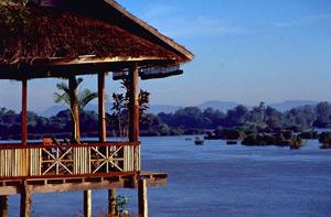 Laos children fishing net bamboo poles riverbank trees sunshine