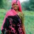 Bharatpur, Rajasthan, India: A colourfully sari-clad tribal lady cuts grass in Keoladeo Bird sanctuary.