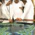 Crown Prince Sheikh Mohammed bin Rashed al-Maktum (R) looks at a display showing the Atlantis man-made island project during a launching ceremony of the luxurious 2,000-room resort and water theme park off the coast of Dubai, 21 September 2003 at a hotel in the Gulf emirate. The 650-million dollar first phase of the Atlantis' project, which is inspired by Kerzner International's Paradise Island in the Bahamas, adds to a boom in tourist infrastructure investment in Dubai, including the construction of dozens more five-star hotels. The project is a joint venture between Kerzner and Dubai's property developer Nakheel LLC.
