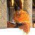 A monk at Luang Prabang's Wat Saen bundles up on a cold February day.