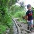 A young boy demonstrates the miracle of "Water Running Up"