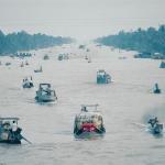 Boats laden with goods make their way down a canal in the Mekong Delta, one of seven such canals that meet near the town of Phung Hiep.
