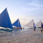 Sailing boats with their colourfuls sails park at the Boracay beach in the Philippines