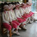 Charming caddies in cute uniforms at the atrocious Korean hotel down the dirt road from Khanh's land.