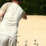 A casual game of pétanque. This sport is part of the 25th SEA Games in Laos.