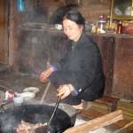 Mama cooks our dinner on an open fire in Pac Ngoi, Ba Be National Park, Vietnam