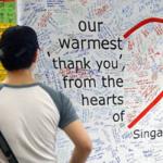 A man reads messages by Singaporeans' thanking health-care workers caring for SARS patients. Over 1,200 handwritten messages of gratitute and encouragement were displayed in this subway station.