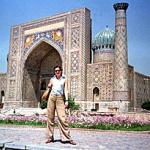 A tourist poses in front of Ragestan palace, in the ancient Uzbek city of Samarkand. This large city of Islamic art was founded in V century B.C.
