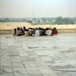 Agra, India. A remarkably numerous group of Indians takes a break on the polished stone of the Taj Mahal, where the opening scene of the movie Pardes takes place.