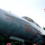 MiG-21 fighter plane at Army Museum. The Flag Tower, a local landmark, flies the national flag in the background.